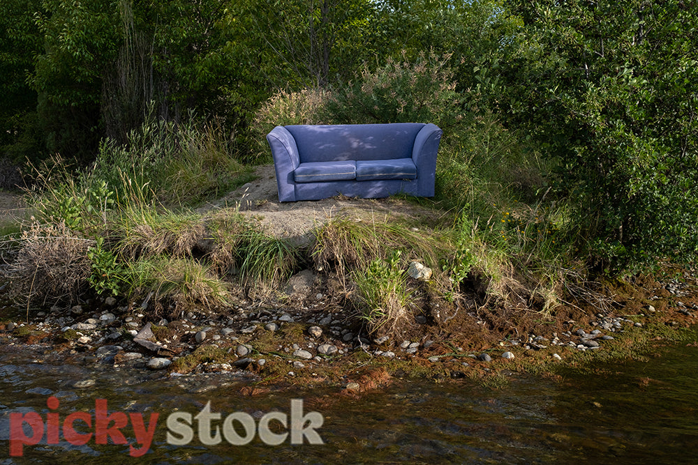 Couch sits beside lake in Central Otago