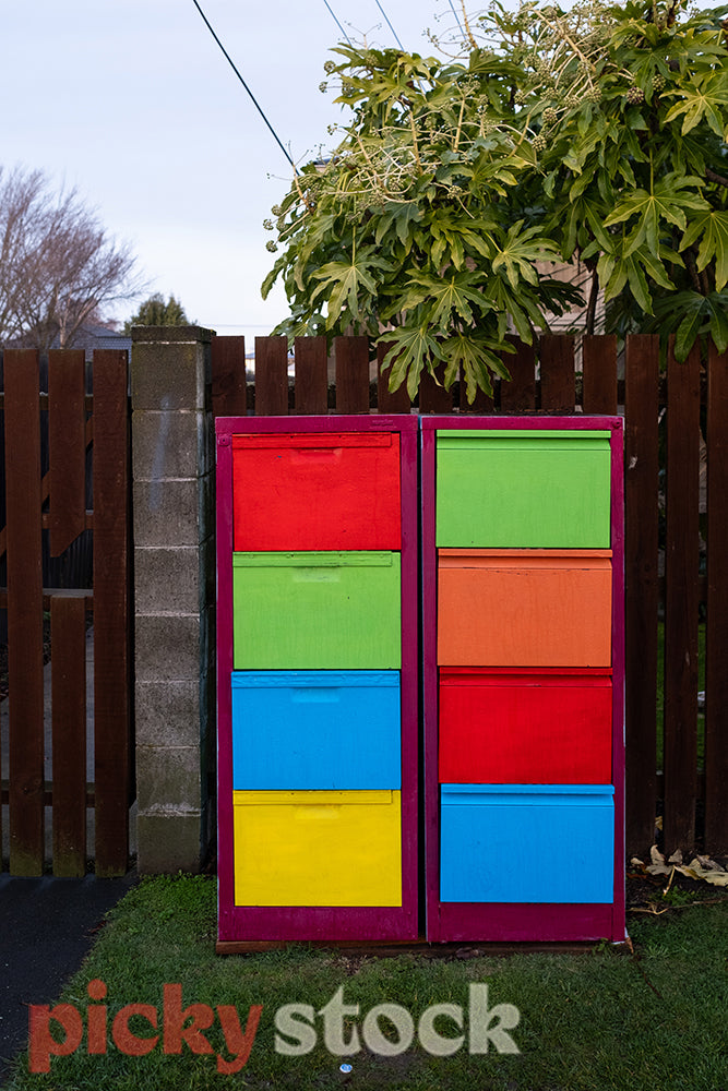 Set of colourful cabinets sit on street