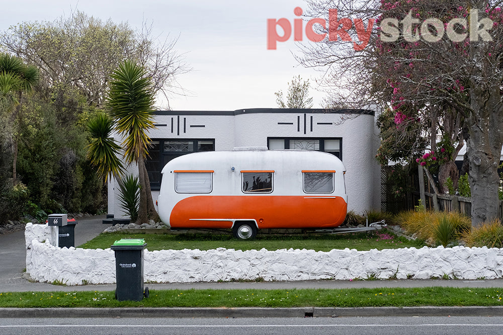 Bright orange caravan and house