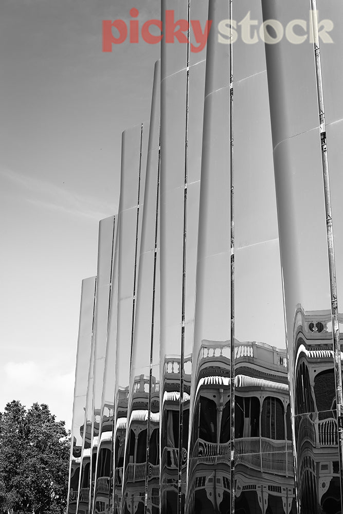 Black and white image of the Len Lye center in New Plymouth with reflections of the nearby buildings.