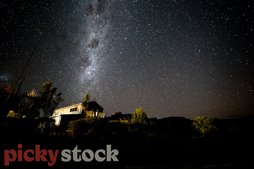 Milky way over a classic kiwi bach on Lake Taupo, Omori