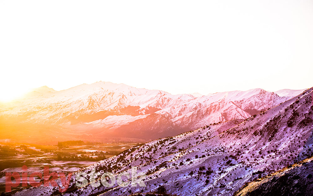 Overlooking the sun setting on Queenstown from the Crown Range on a winter day.