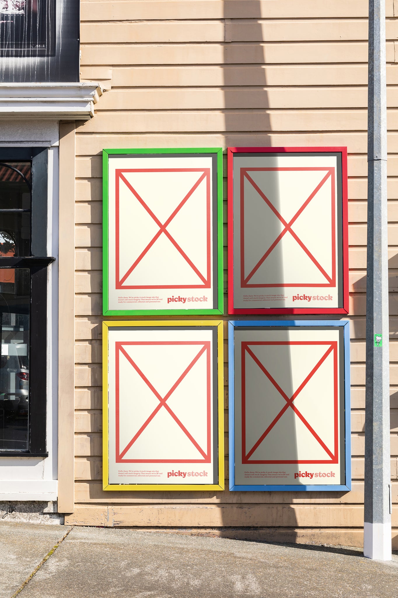 Portrait of framed advertisements on a neo victorian building the multi-colored framed held blank white and red mock advertisements with picky brand logos.
