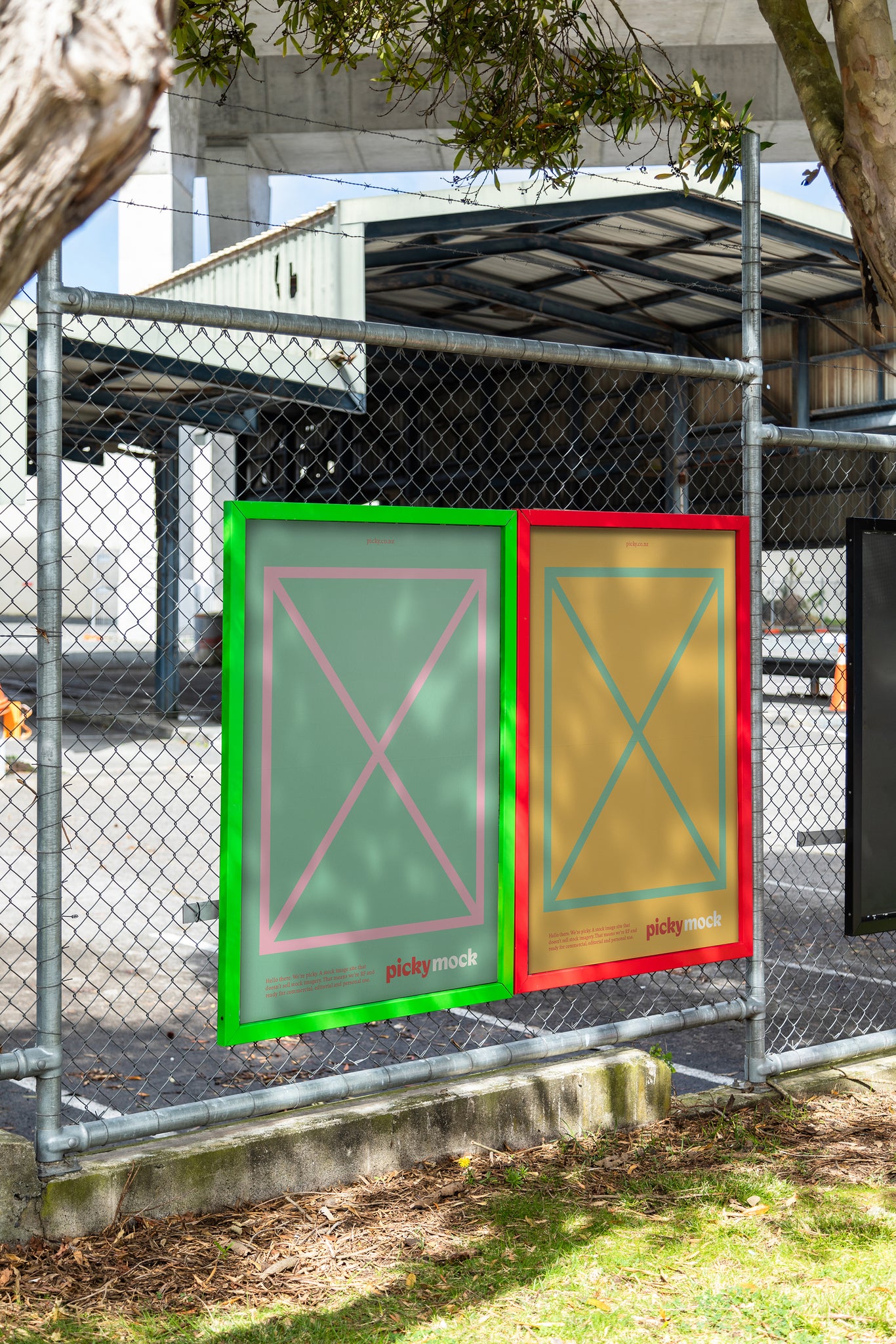 Portrait of colorful advertisement frames on a wire fence sheltered by trees, the frame holds green and yellow mock advertisements with a small red picky logo.