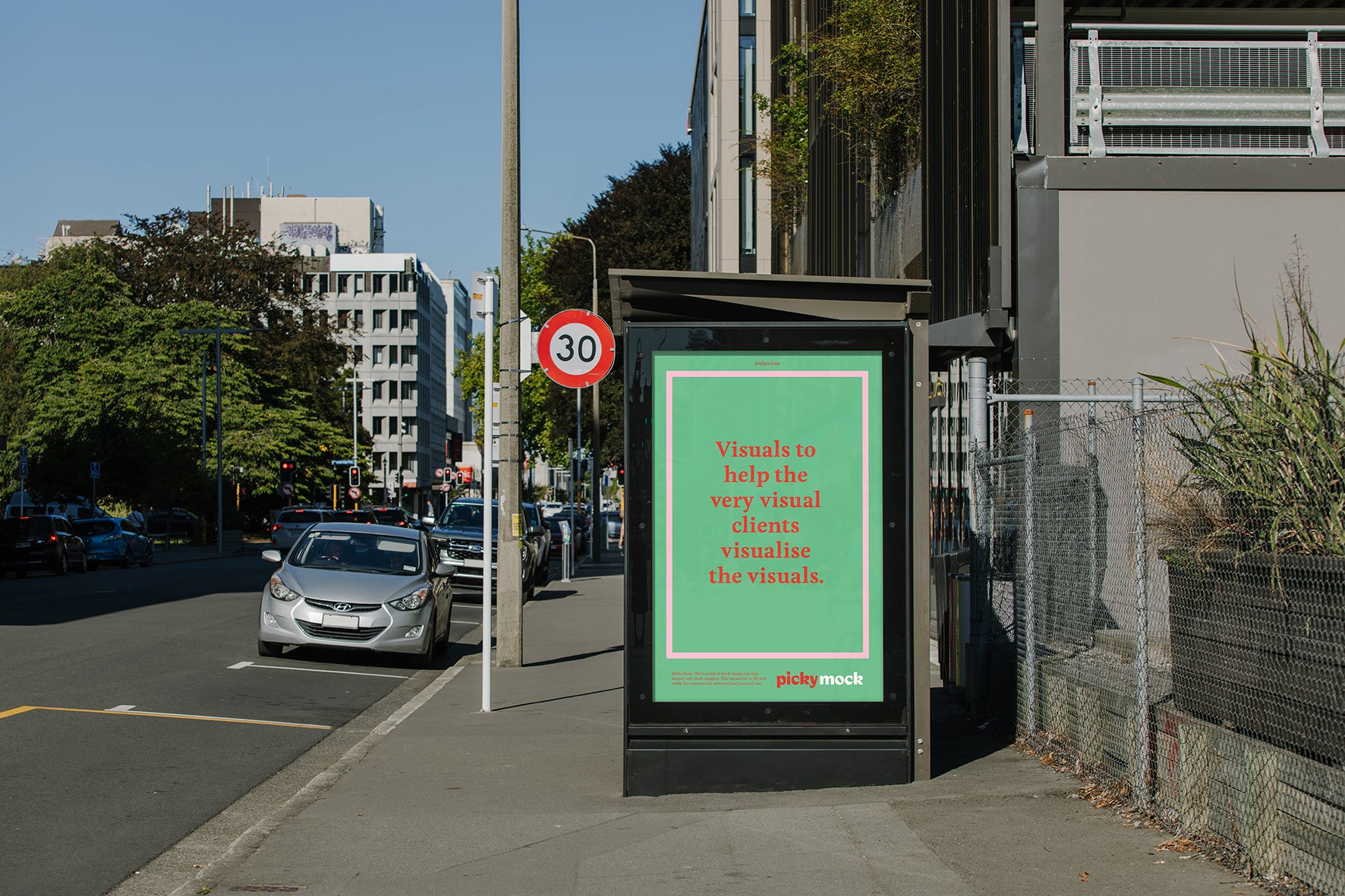 Bus stop advertising on a calm urban street.
