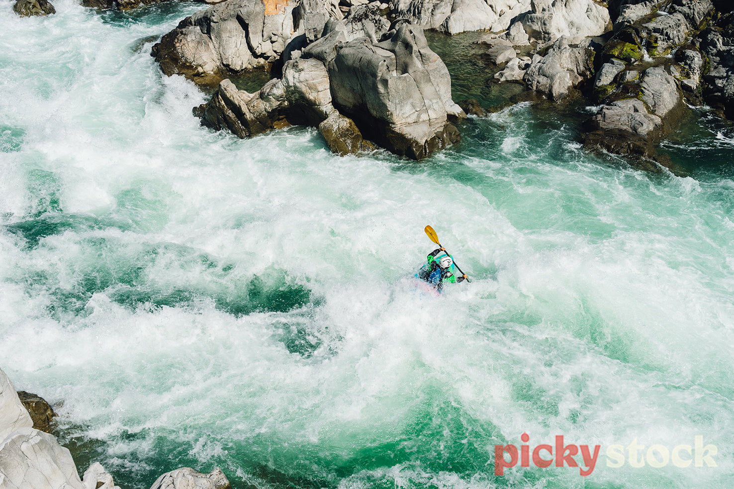 Whitewater kayaker in an ice cold rapid.