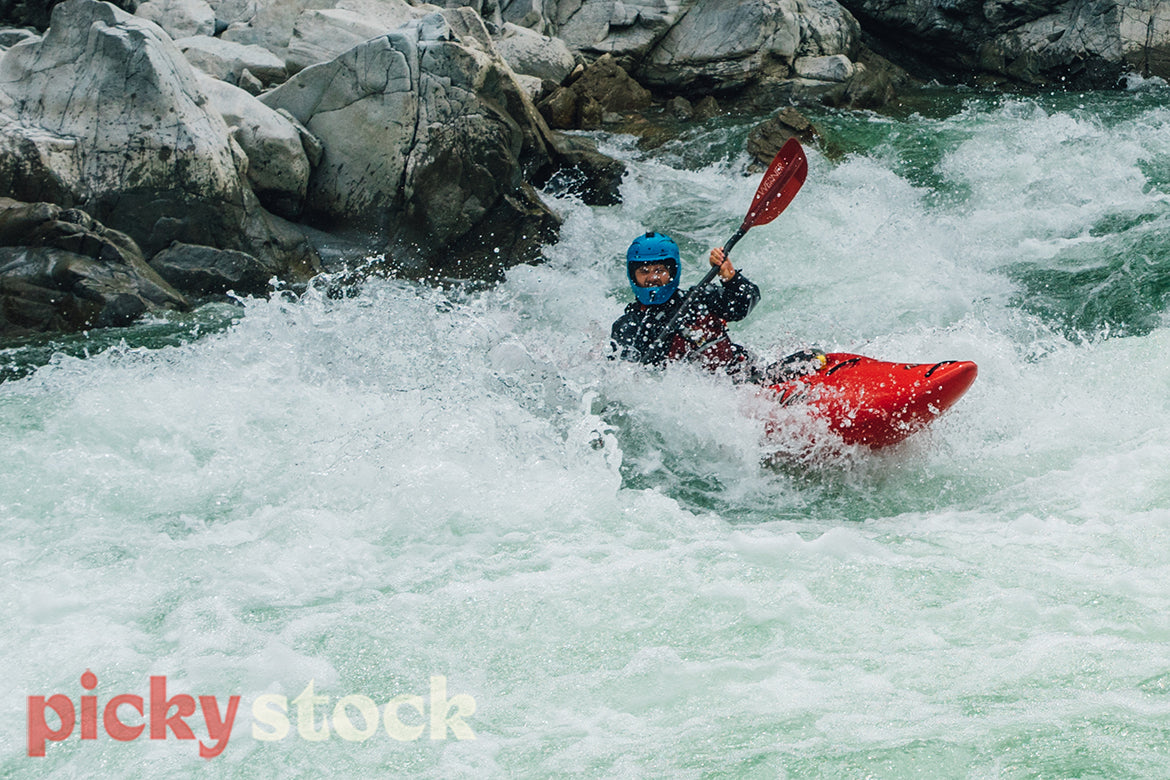 Whitewater kayaker in a rapid