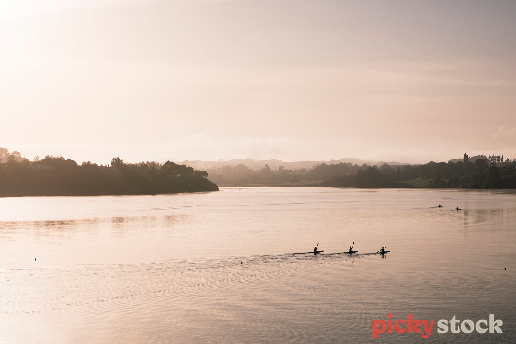 Kayakers on Lake Karapiro early morning.