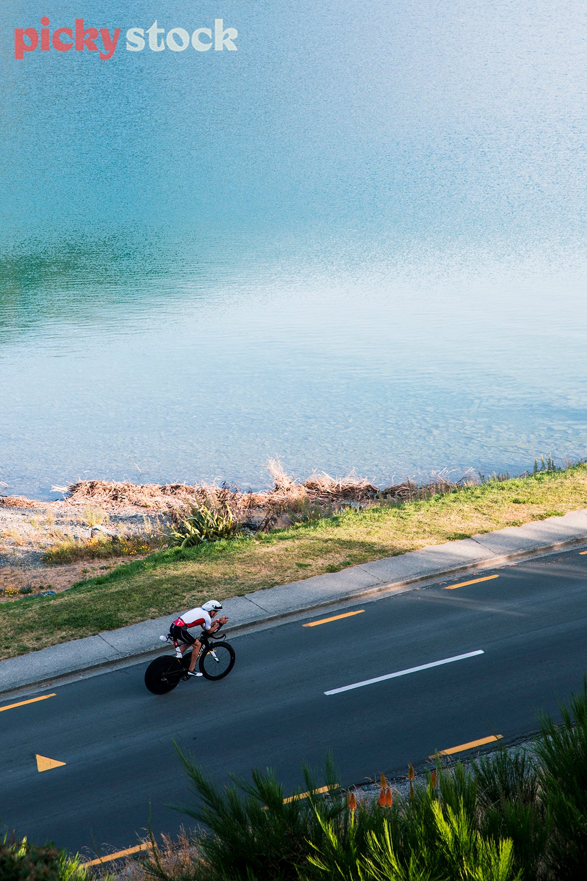 Athlete moving around Lake Hawea on the bike.