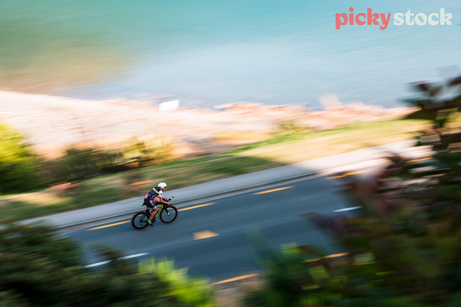 Cyclist moving fast around Lake Hawea.
