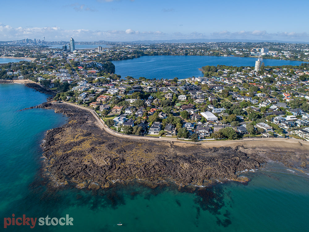Aerial views of Lake Pupuke by helicopter. Auckland sky tower on horizon. 