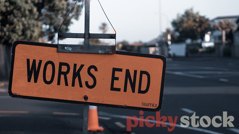 "Works end" construction sign on the side of the road.