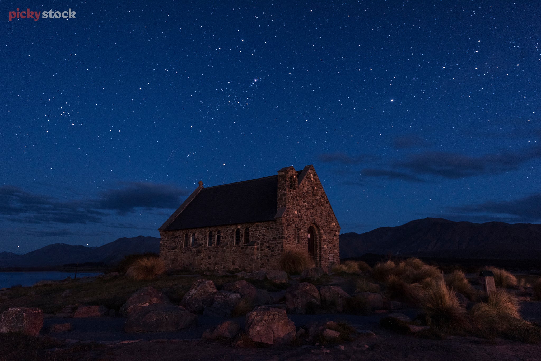 Deep blue evening looking up to the un-light-polluted stars behind the classic stone church of the South Island. 