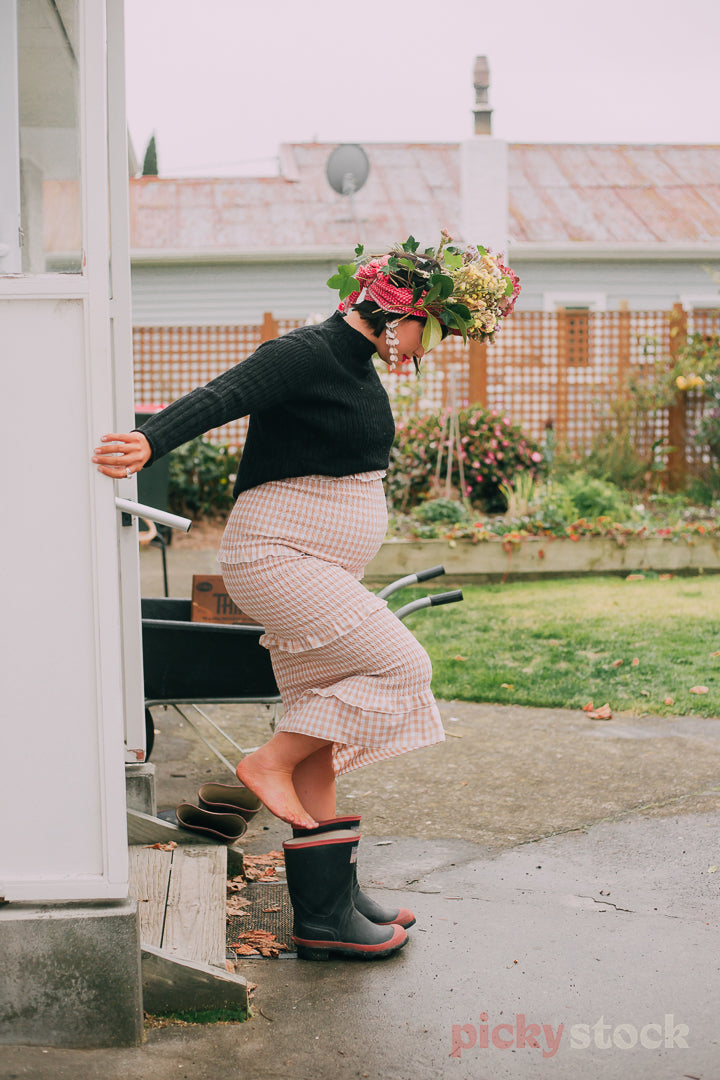 Stepping into red band gumboots.