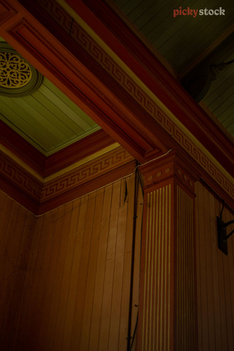 Looking up towards an ornamental ceiling, the woodwork carved out.