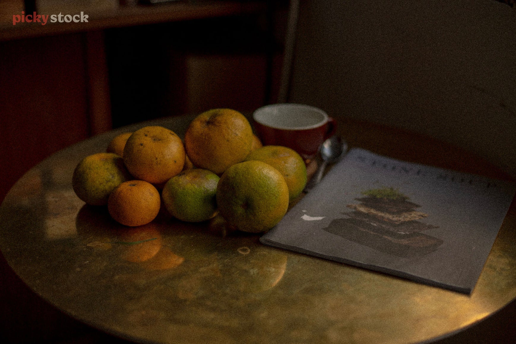 Still life style dramatic scene, with fruit stacked up on table.