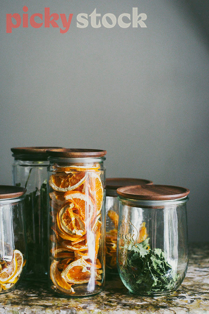 Garnish in trendy glass and wooden jars in restaurant bar.