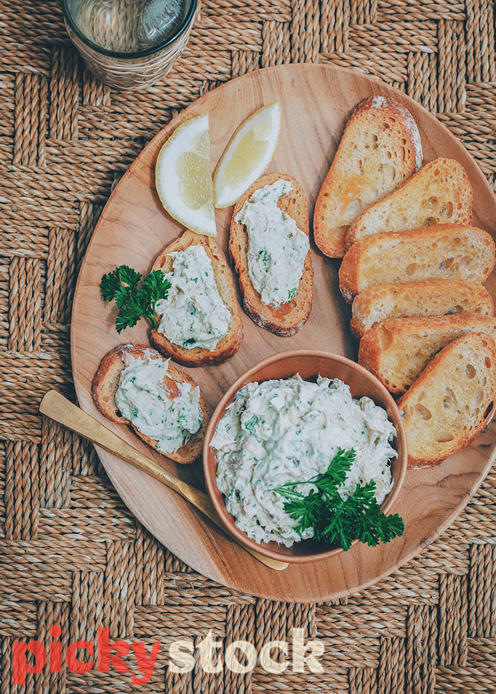 Smoked fish pâte with toasted baguette on platter. 