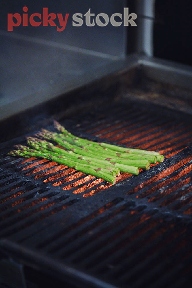 Asparagus on grill of restaurant stove