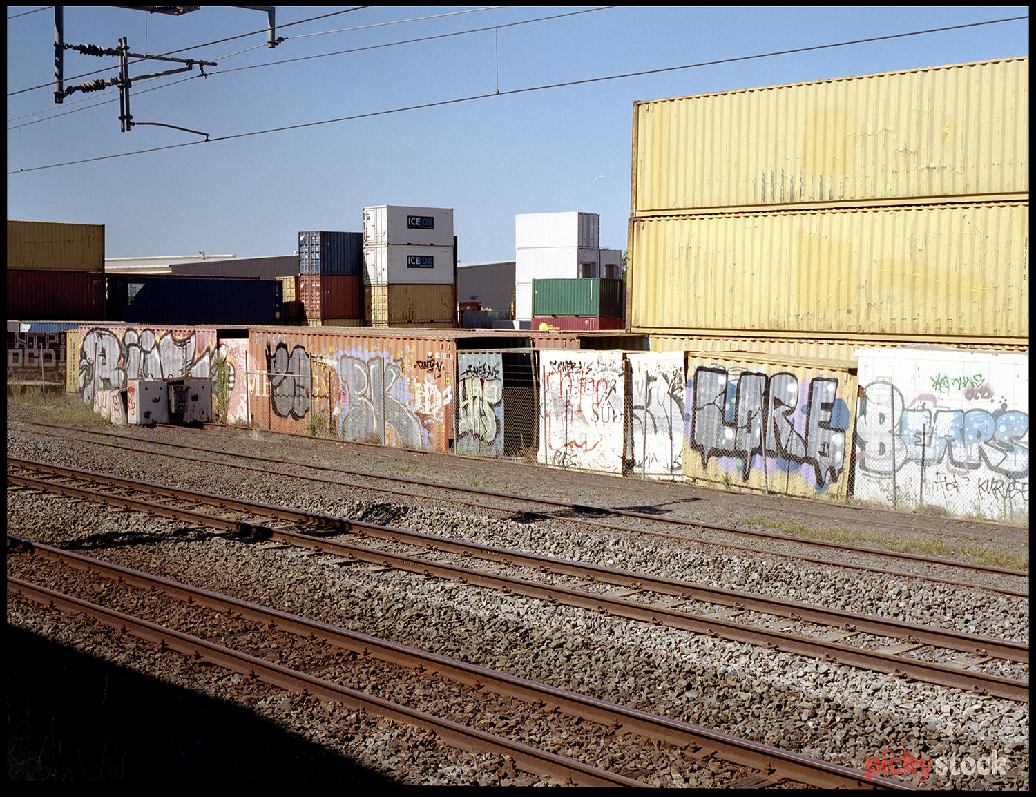 At the railway station, looking out over the train tracks towards the grafitti. 