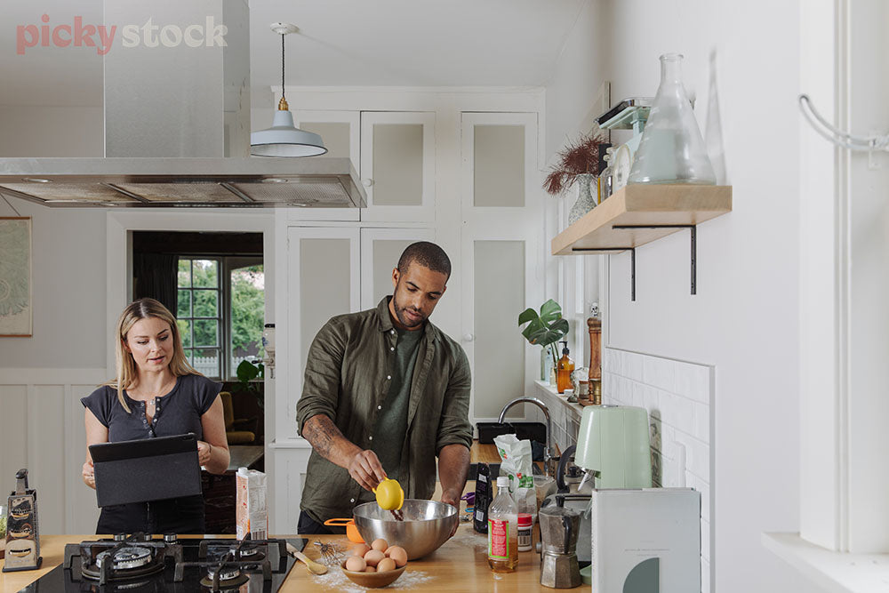 A couple cook using a digital recipe in a New Zealand kitchen