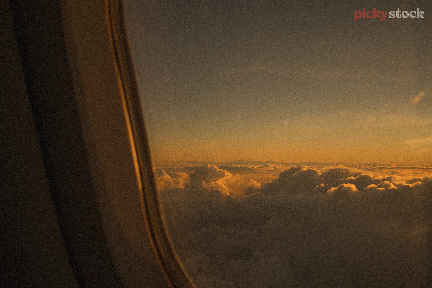 View of golden evening light from plane window. 