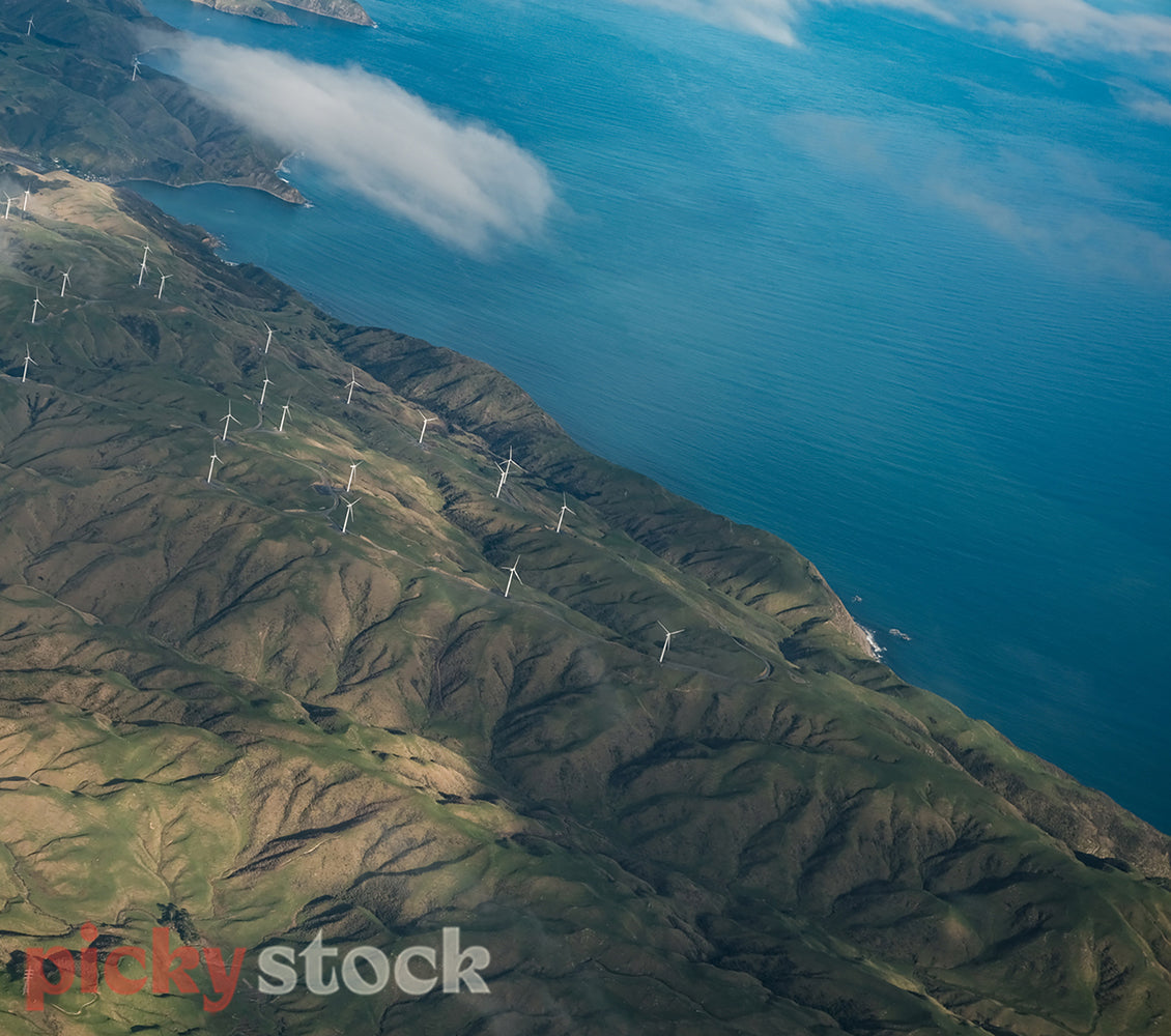 Aerial view of Wellington mountainous region with windfarms, near the coast.