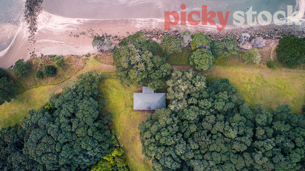 Shot of a cabin in the trees from above